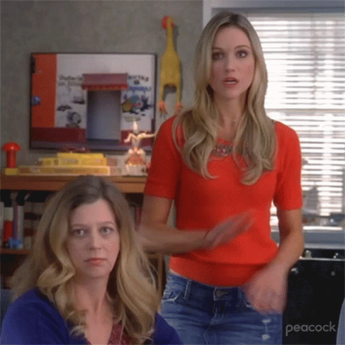 Two blonde women shaking their heads and gesturing no